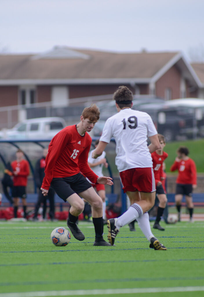 Southern Boone High School forward Landon Beeson, center, advances on the New Covenant Academy High School goal